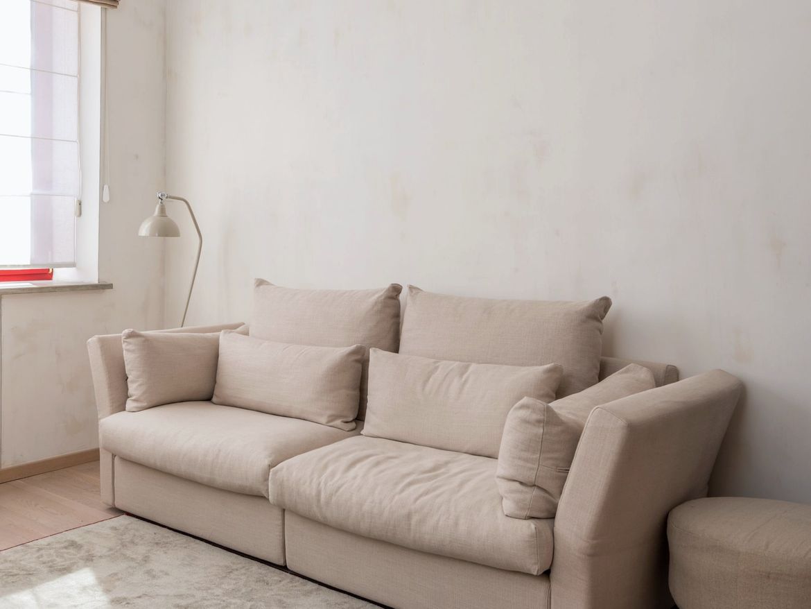 Bright living room with a beige fabric sofa after cleaning